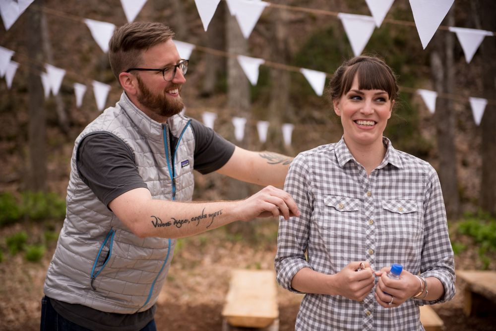 Outdoor celebration with white bunting flags strung between trees during a casual gathering.