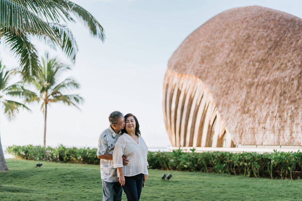 Scenic view of a beachfront resort with distinctive dome-shaped architecture and palm trees.