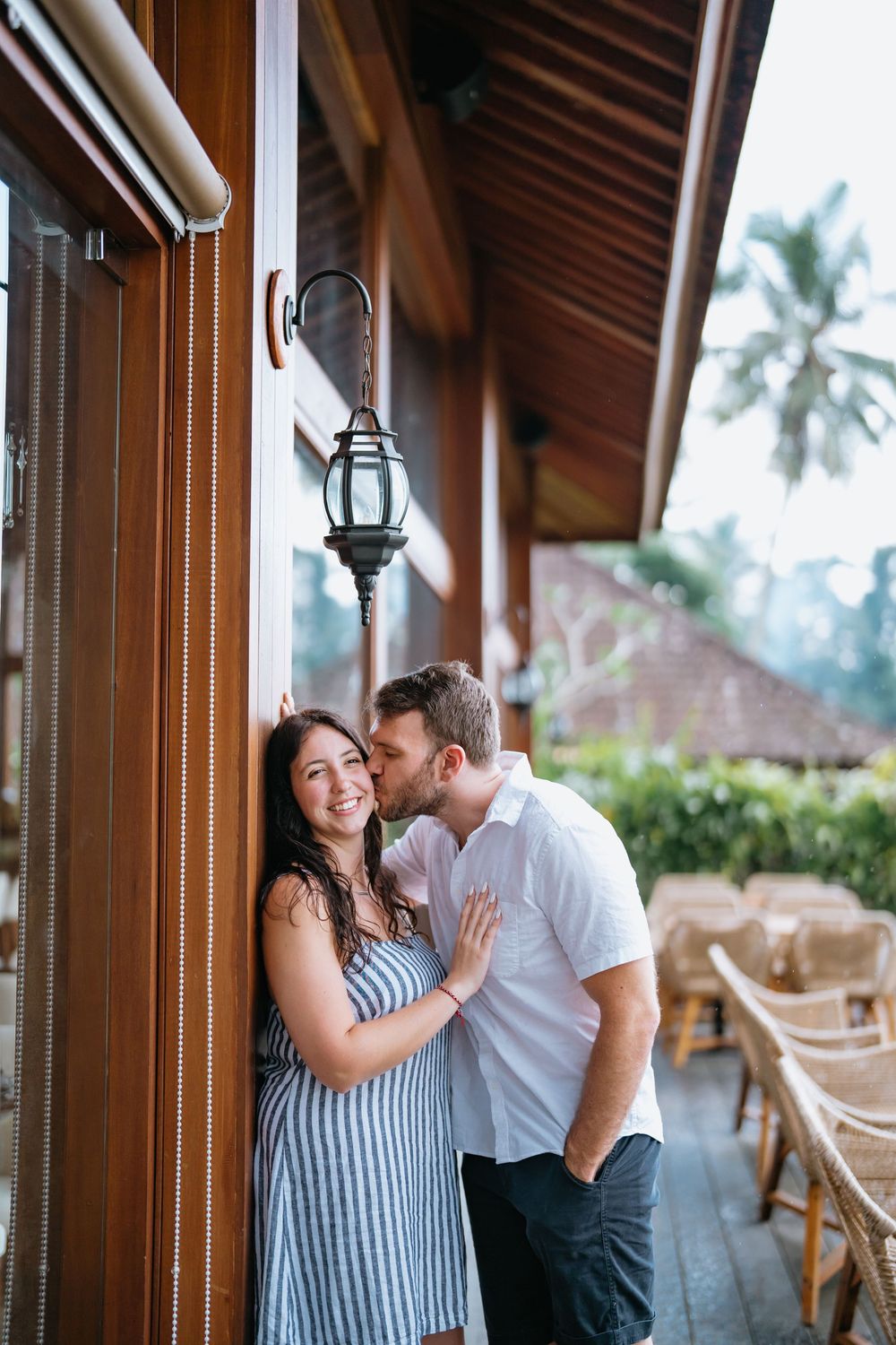 Romantic moment captured under hanging lantern at luxury resort.
