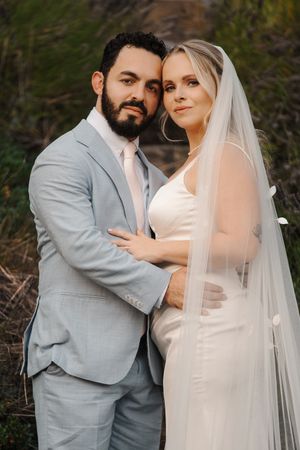 A romantic wedding photo series showing a couple in an outdoor setting with a bride in white and groom in light gray suit.