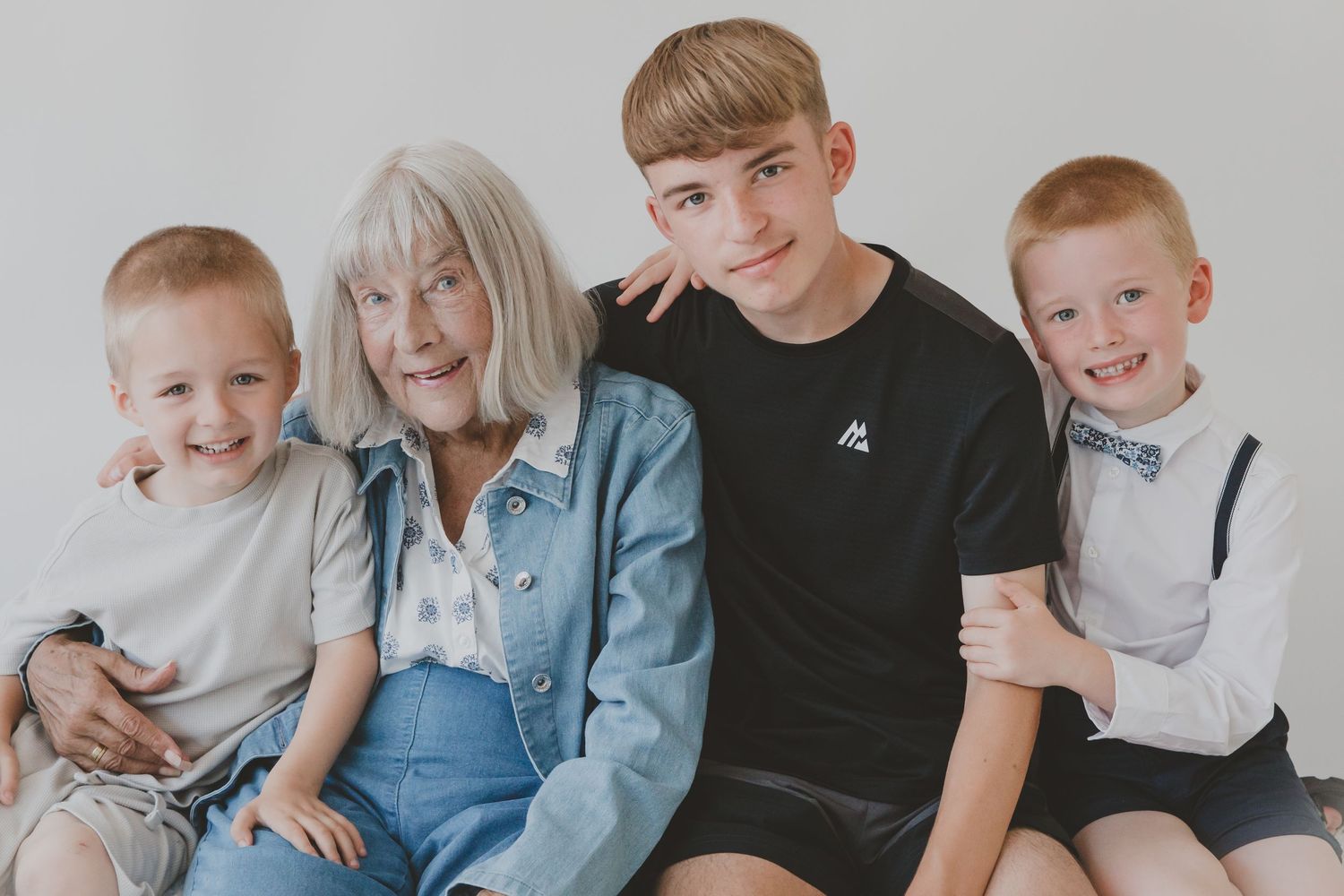 Beautiful family portrait - Grandmother, Nain and her three handsome grandsons. Studio photoshoot. colour. Llanfairfechan. North Wales.