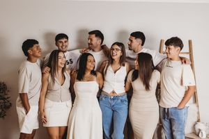Group portrait series with people wearing white tops and blue jeans in a minimalist setting.