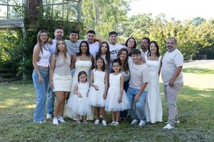 Outdoor family group photos with everyone dressed in white and casual attire in a natural setting.
