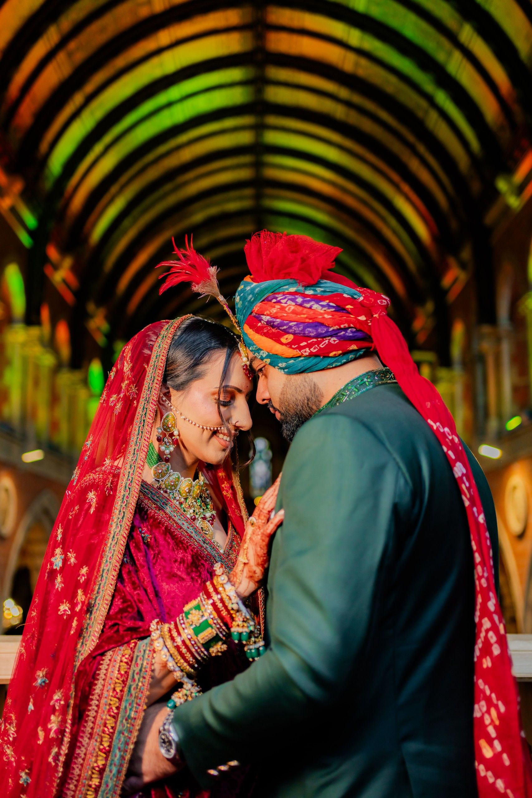 Rohita and Hiran beneath a colourful vaulted ceiling