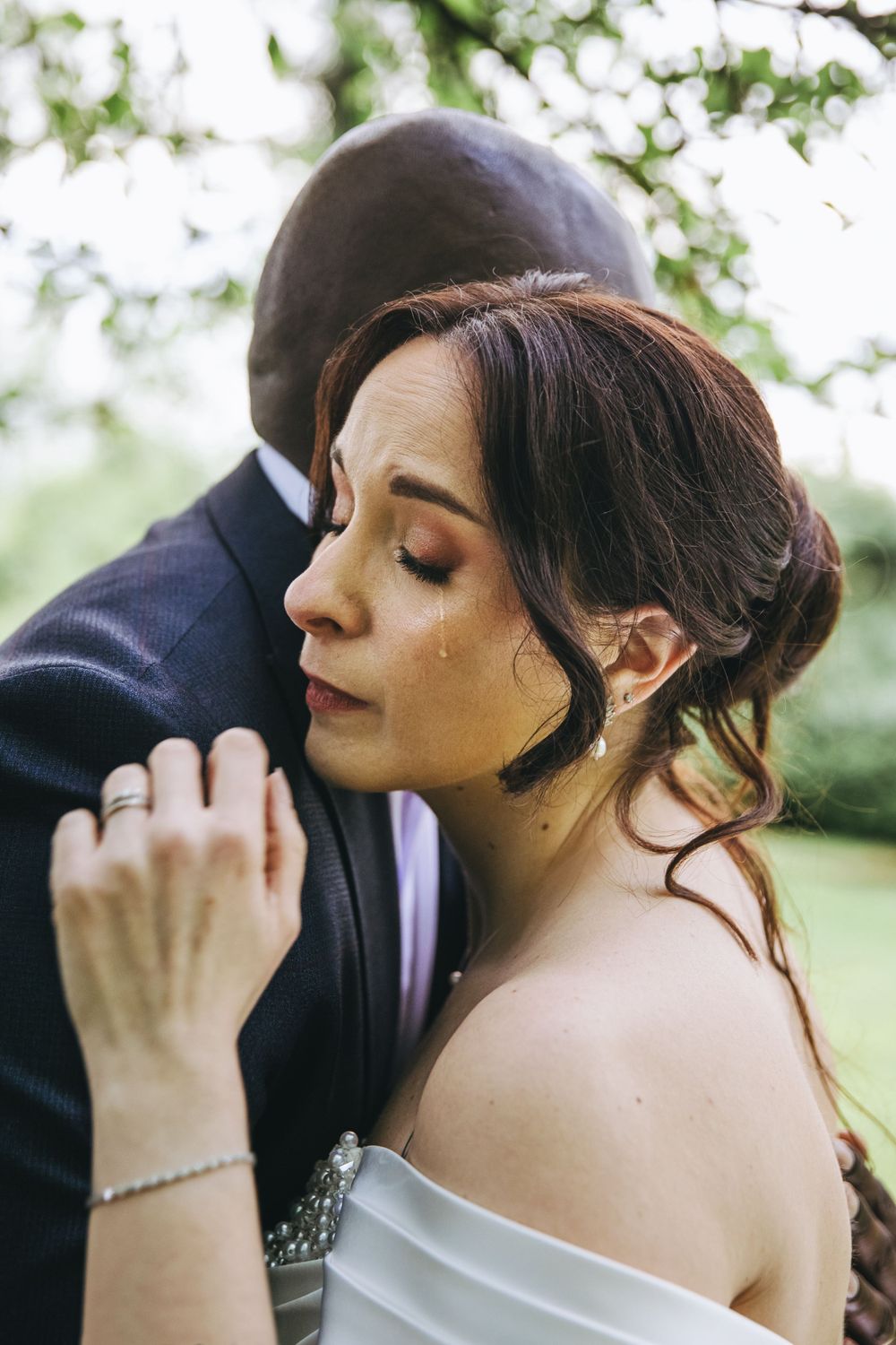 An intimate wedding portrait capturing a tender moment with soft natural lighting.