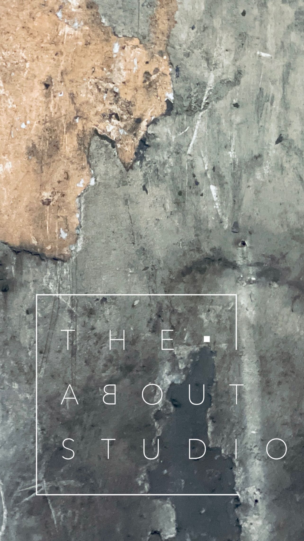 Distressed concrete wall texture with 'THE ABOUT STUDIO' text overlay.