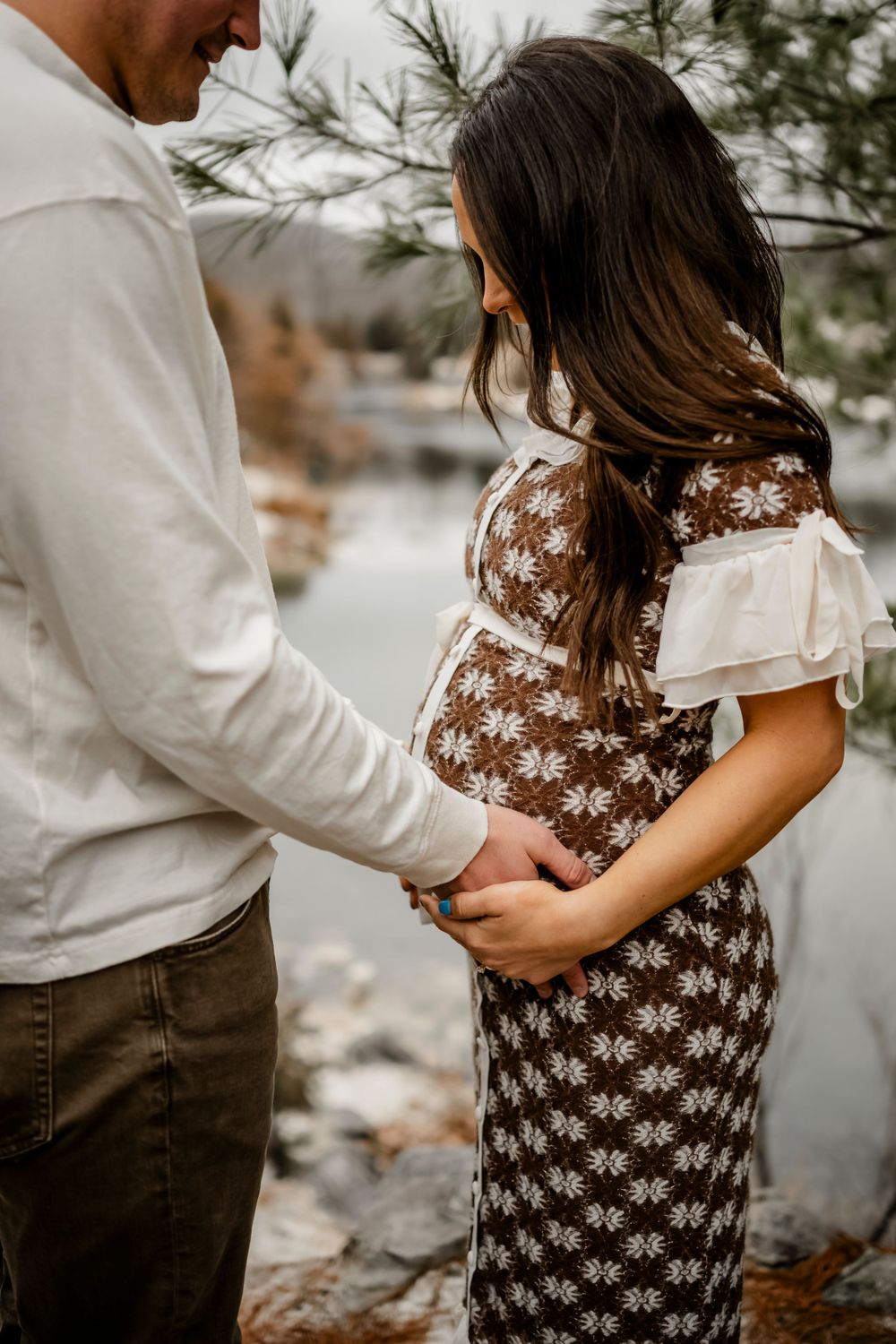 Intimate outdoor maternity photos showing couple embracing during pregnancy.