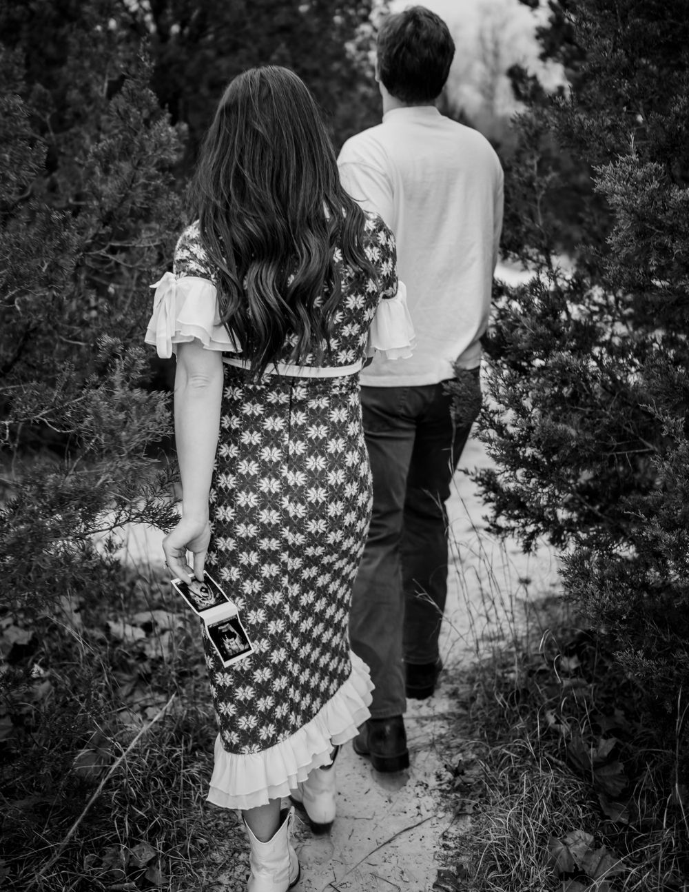 Black and white photo series capturing intimate moments between a couple outdoors.