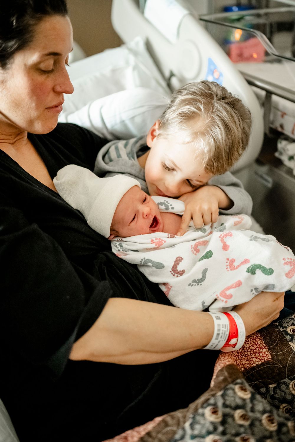 Peaceful moments shared between family members and their newborn in the hospital.