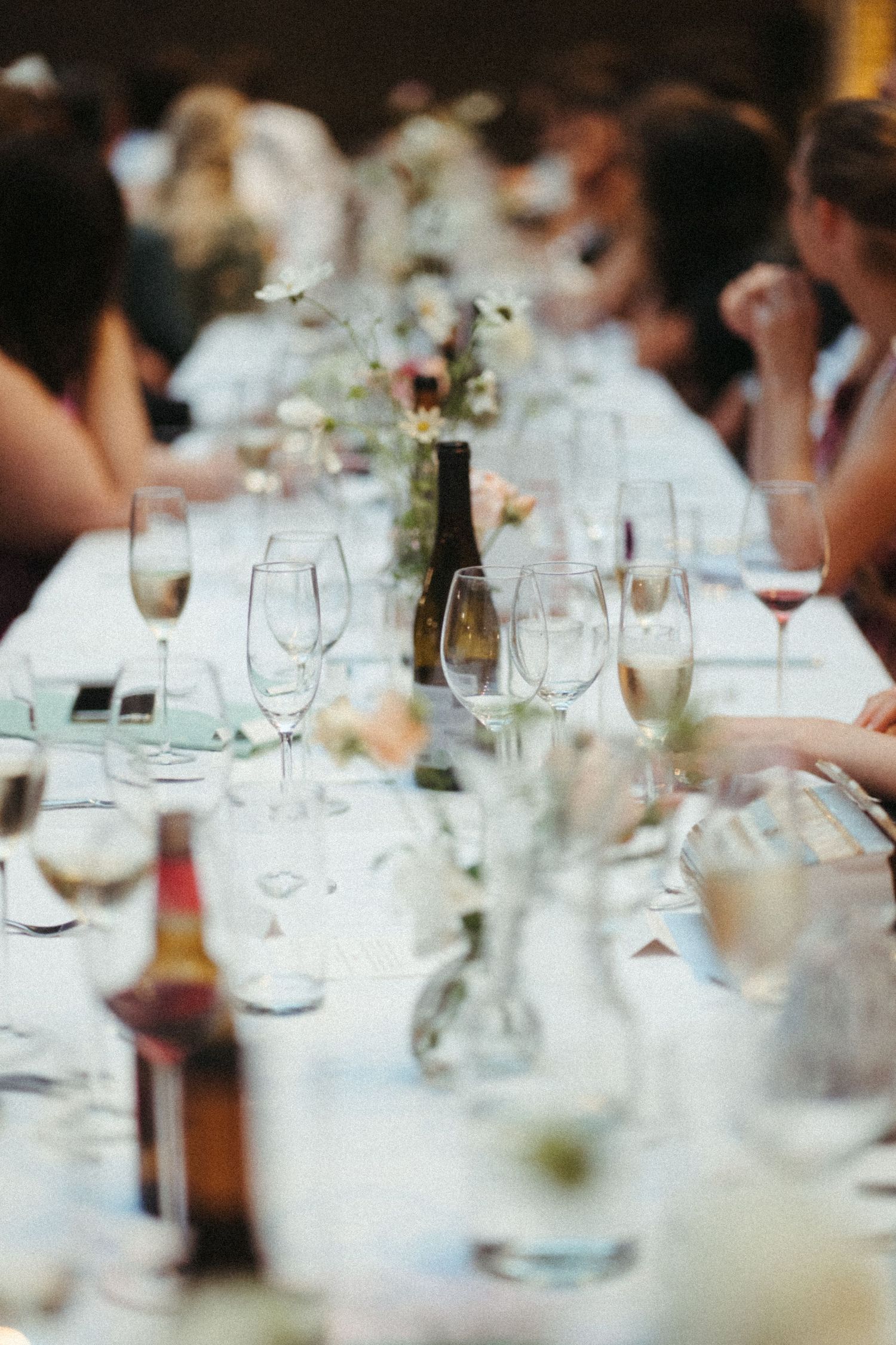 A formal table setting with wine glasses and place settings at an elegant dinner party or reception.