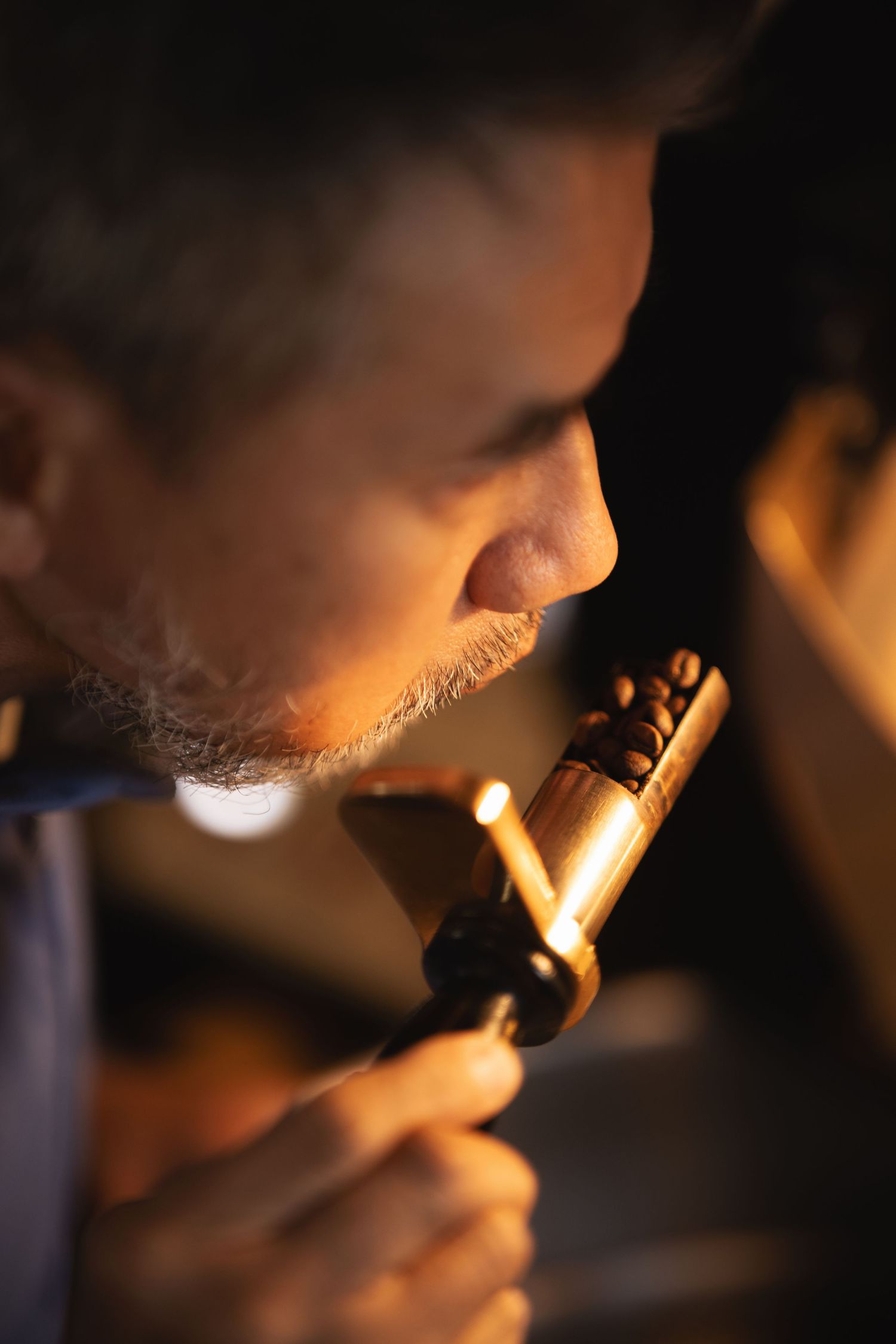 Close-up portrait of a man lit by warm candlelight at Mettricks Portswood Southampton, moody atmospheric lifestyle photography