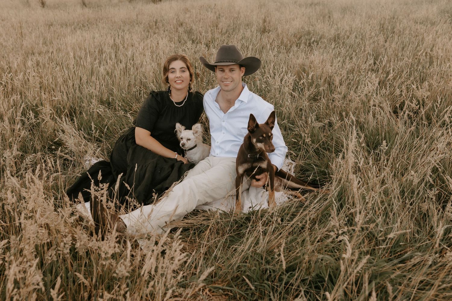 Family portrait session in a golden field during sunset.