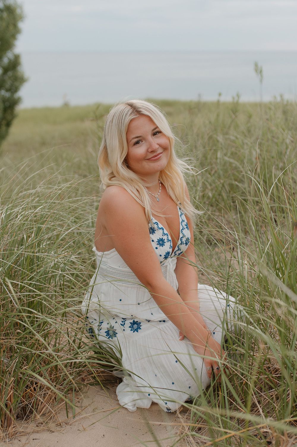 A summer portrait in tall beach grass wearing a floral dress.