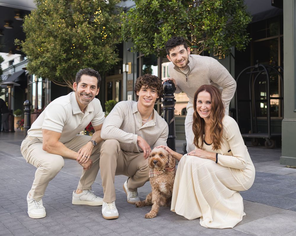 Modern family lifestyle portraits with a pet dog in an urban setting.