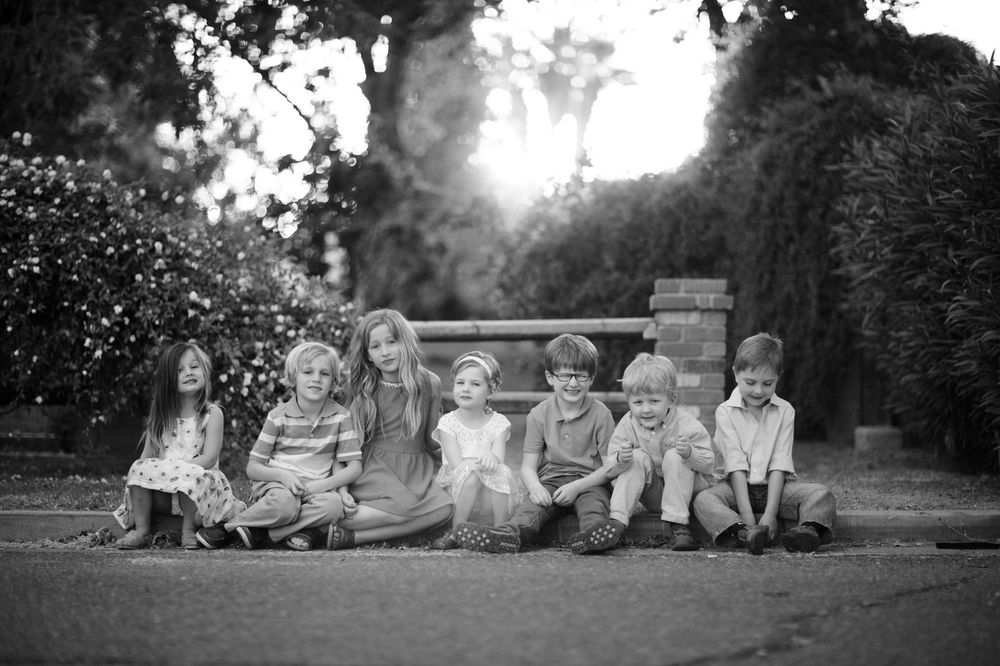 Black and white panoramic series of group portraits in a natural outdoor setting.