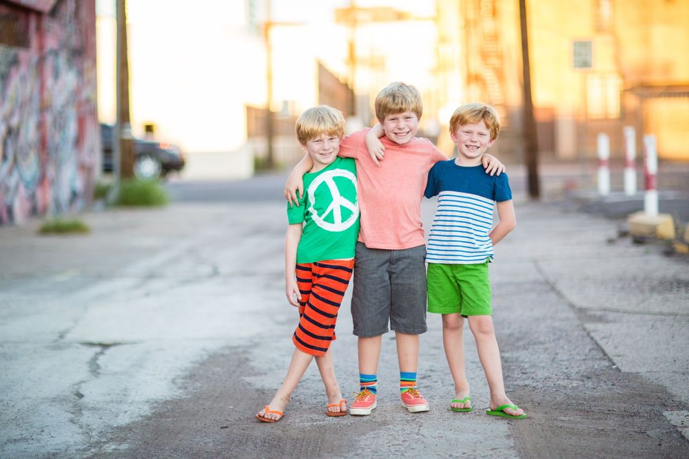 Children playing together on an urban street during golden hour.