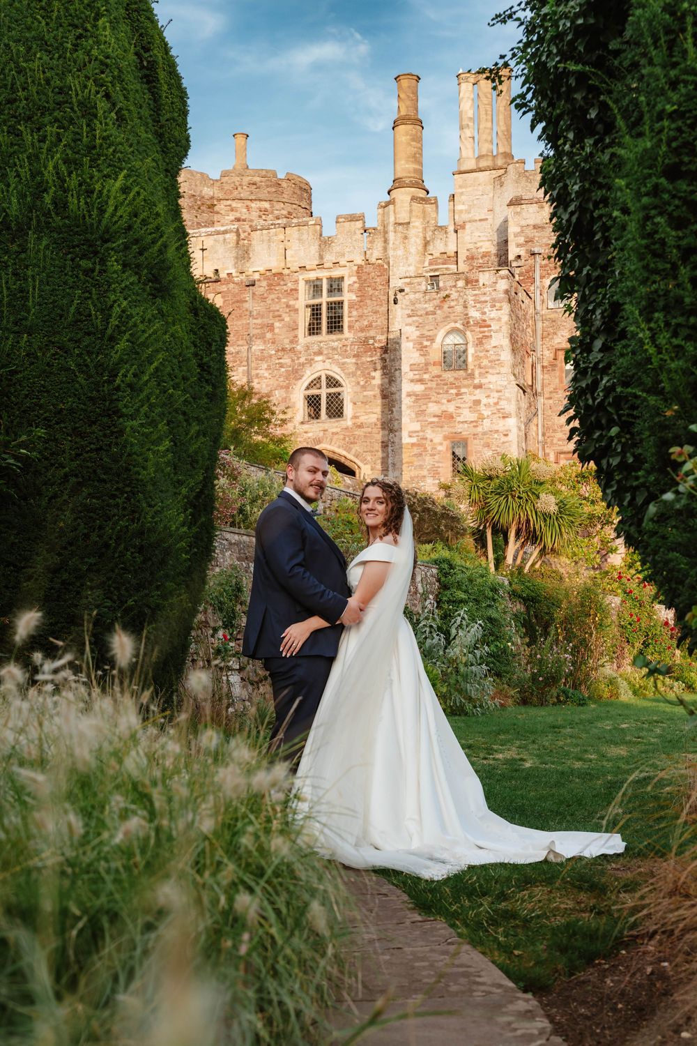 Sunset portraits at Berkeley Castle Gloucestershire Wedding bride and groom with castle in background
