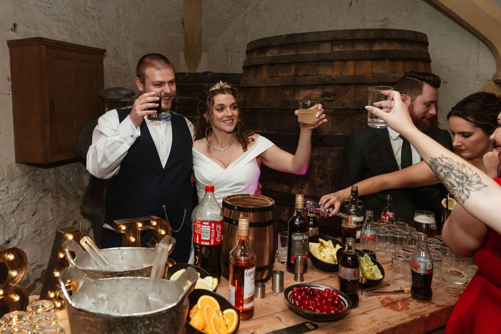Berkeley Castle wedding venue Gloucestershire medieval castle evening reception main hall bride and groom in cellar bar
