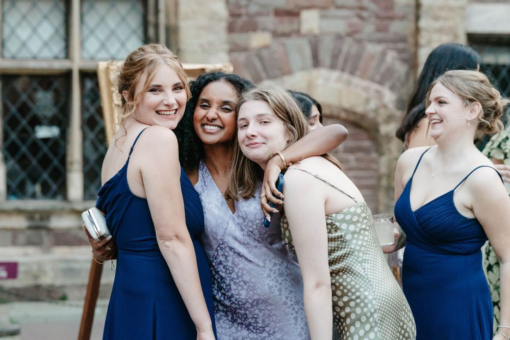 Berkeley Castle wedding venue Gloucestershire medieval castle evening reception main hall guests embracing each other