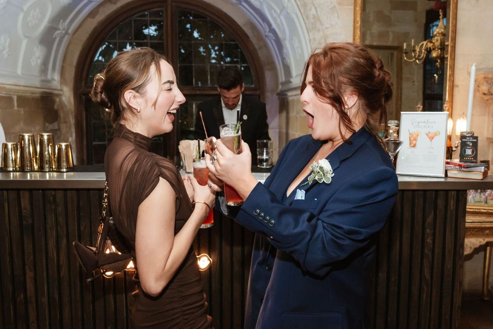 Berkeley Castle wedding venue Gloucestershire medieval castle evening reception main hall guests being very merry with cocktails