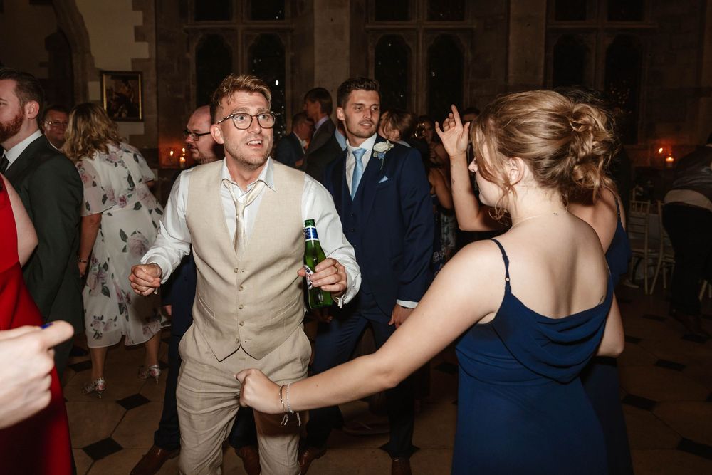 Berkeley Castle wedding venue Gloucestershire medieval castle evening reception main hall guests dancing in main hall