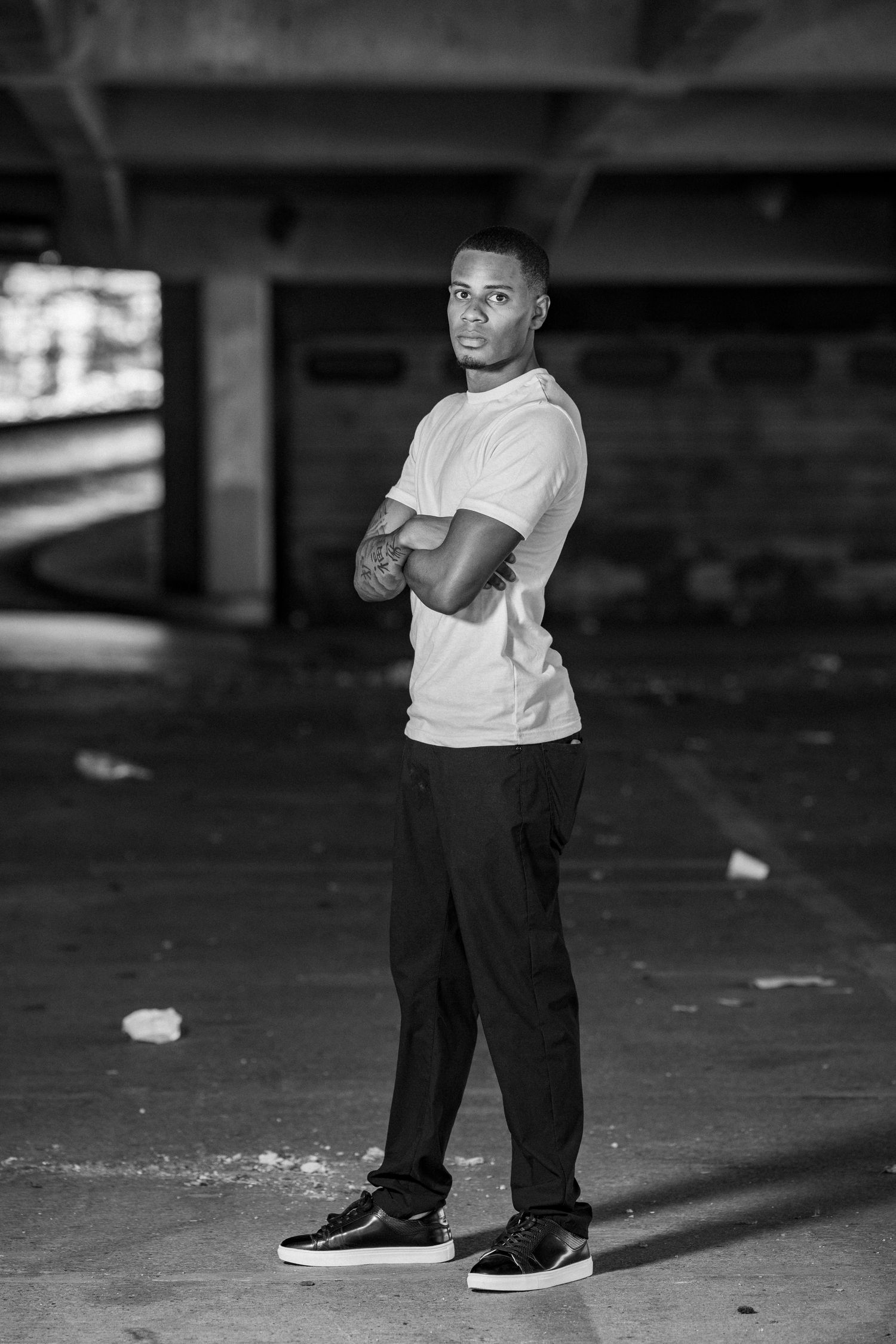 Model / actor posing for a portrait in an abandon parking garage.