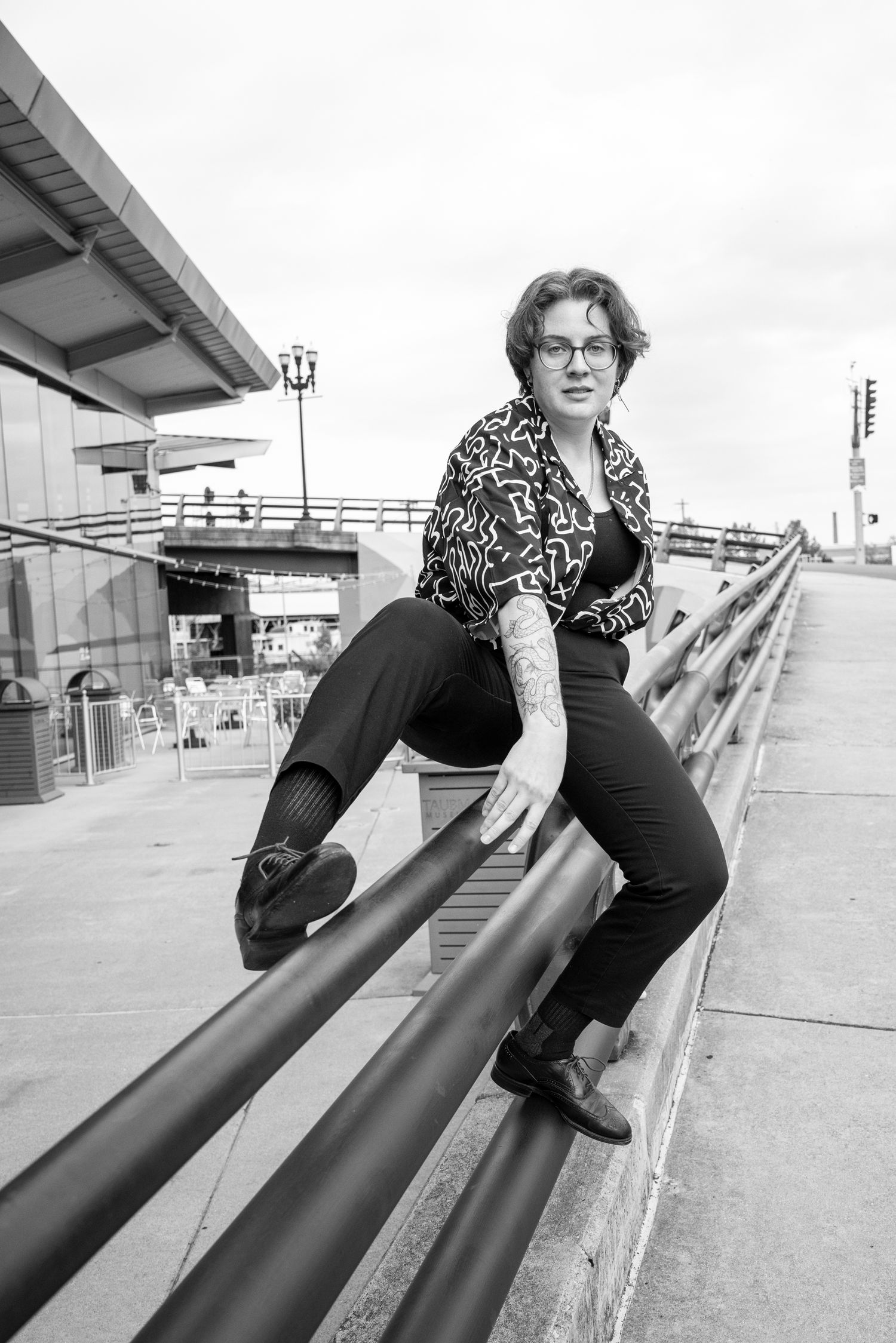 Portrait showing a woman climbing over a railing