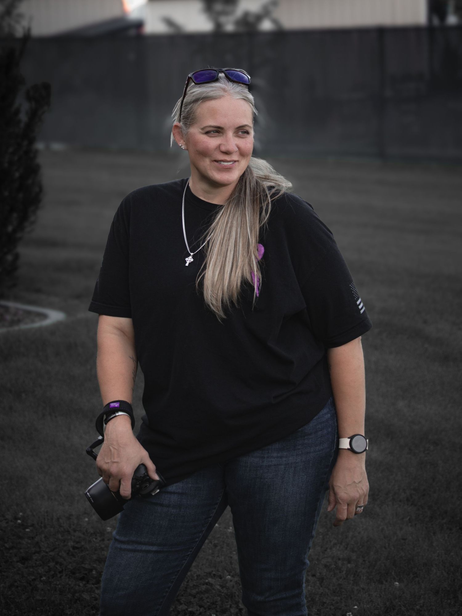 LeAnne of 10.9huis Photography holding her camera during a North Idaho photo shoot, capturing portraits and nature with a storytelling style