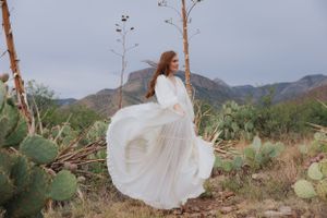 Elegant white dress movement photographed against desert mountain scenery.