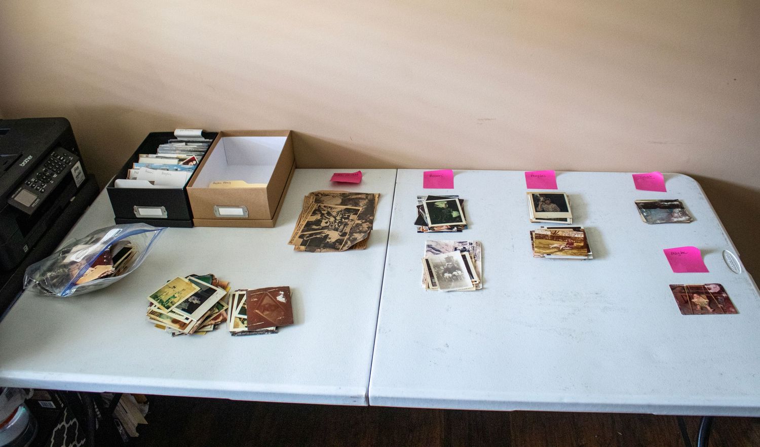 Pictures on a table with notes and small photo box