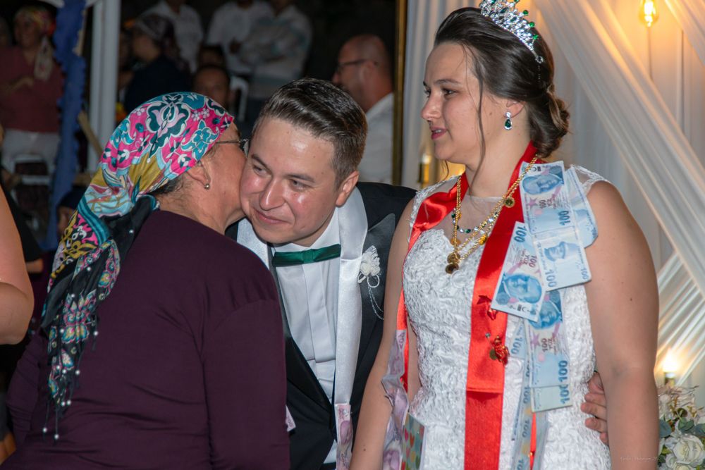 The groom share a lovely greeting with mum inlaw at the reception celebration during a joyful performance indoors.