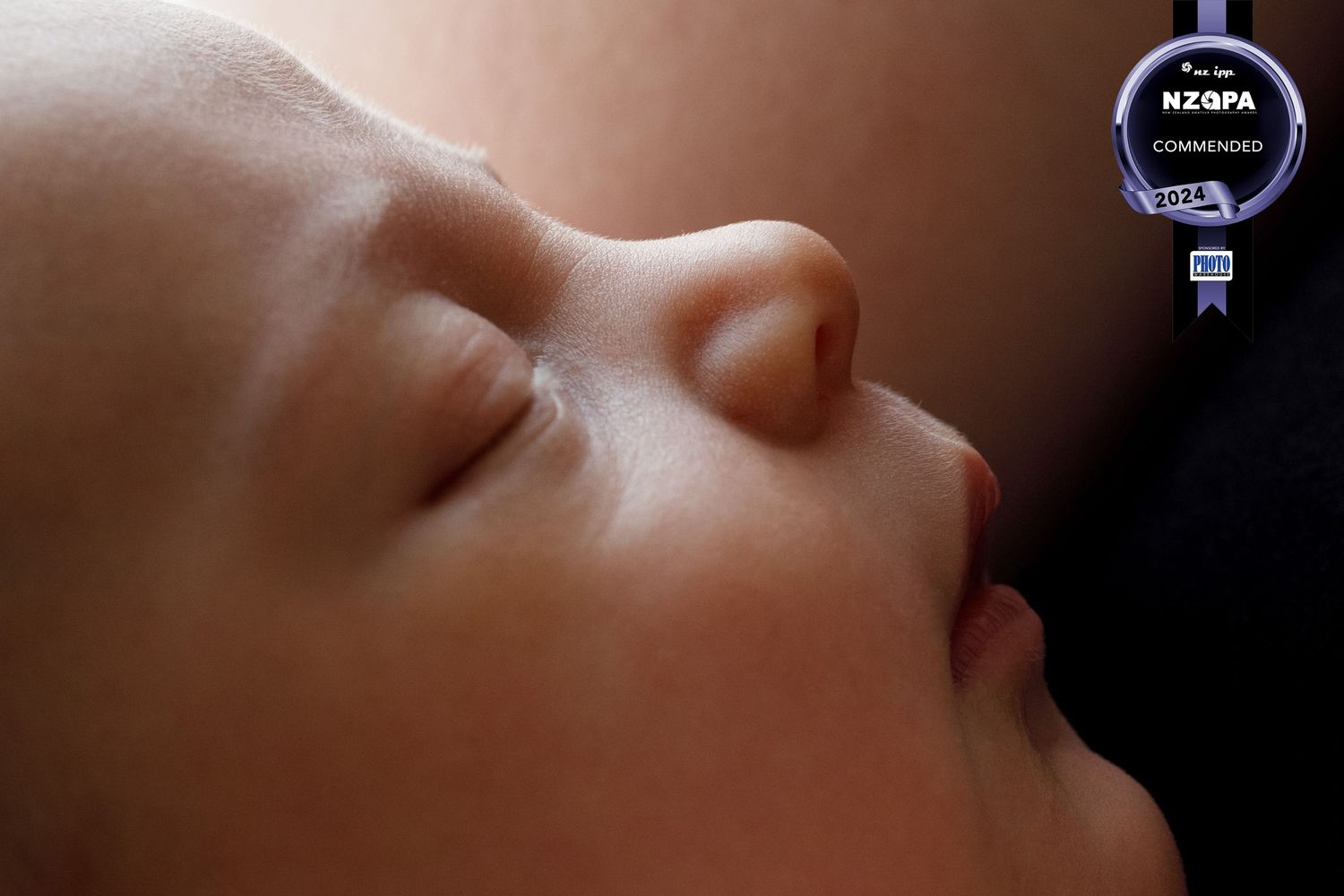 Close up features of a newborn face focusing on the nose.