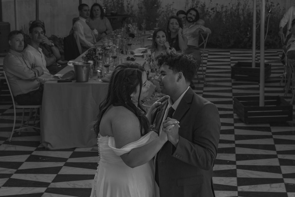 Bride and groom during first dance with guests in view in Sonoma County California