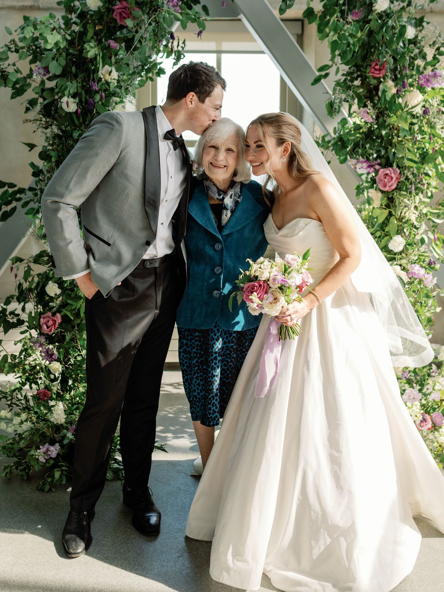 Tender moment shared between a bride, groom, and their grandma at the Isabel Bader Centre in Kingston, Ontario.