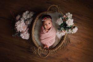 newborn baby swaddled in basket photoshoot in Beaverton Oregon studio