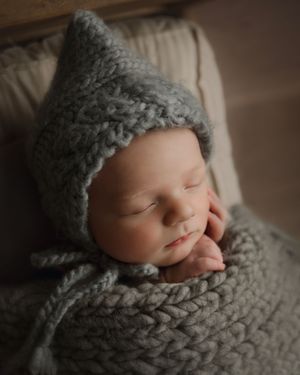 newborn baby wearing a bonnet in Beaverton photo studio