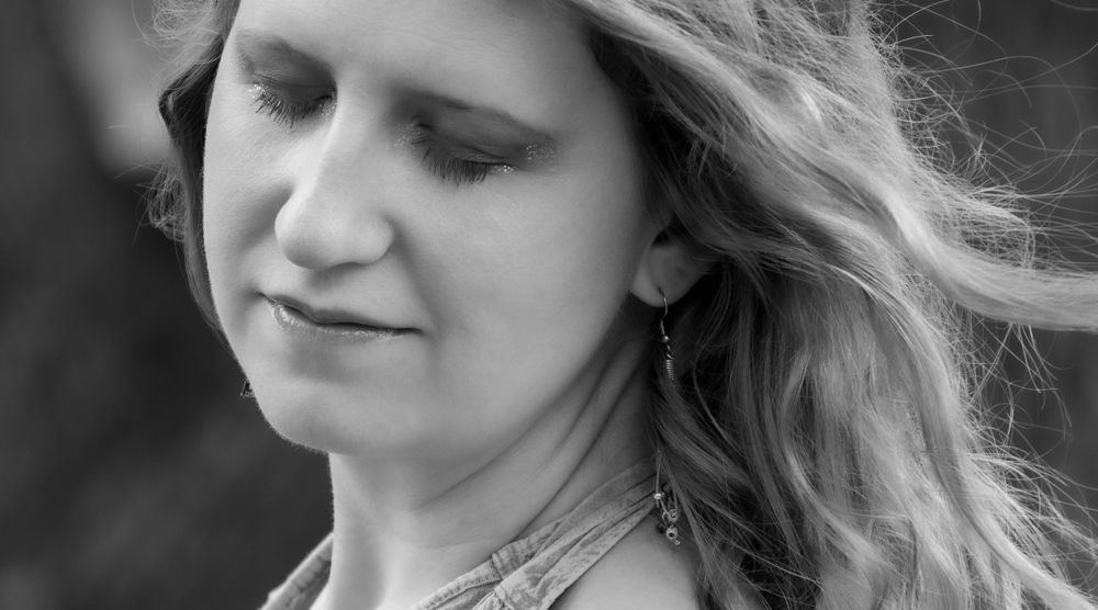 Black and white portrait detail showing flowing hair and natural lighting.