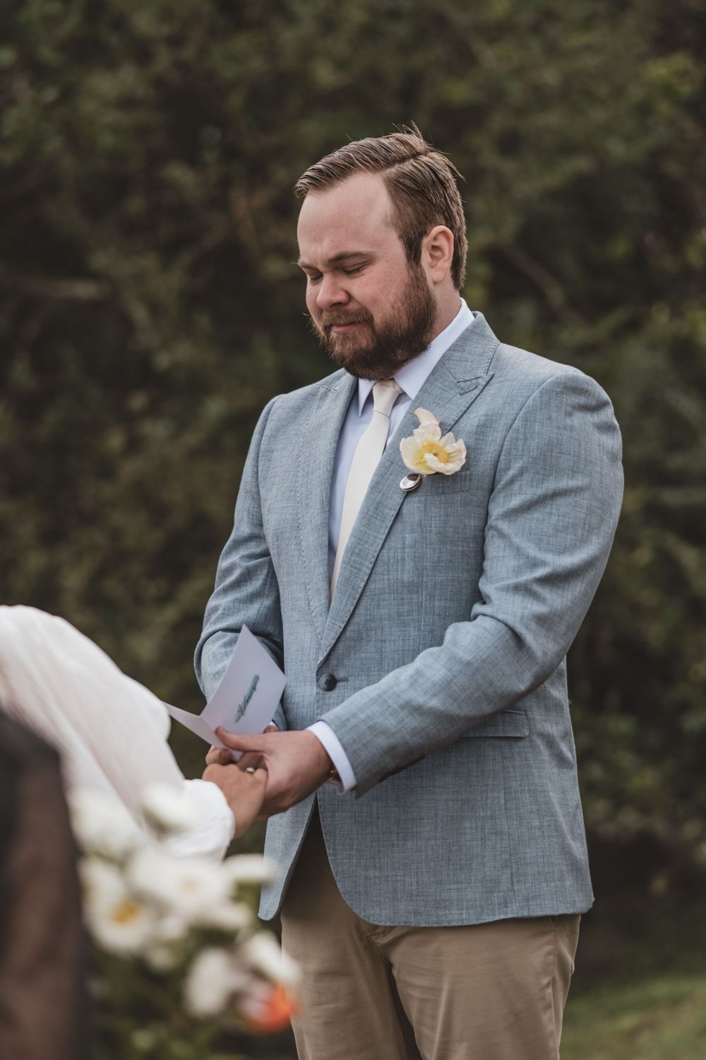 A series of photos shows someone in a gray suit jacket interacting with a white dove outdoors.