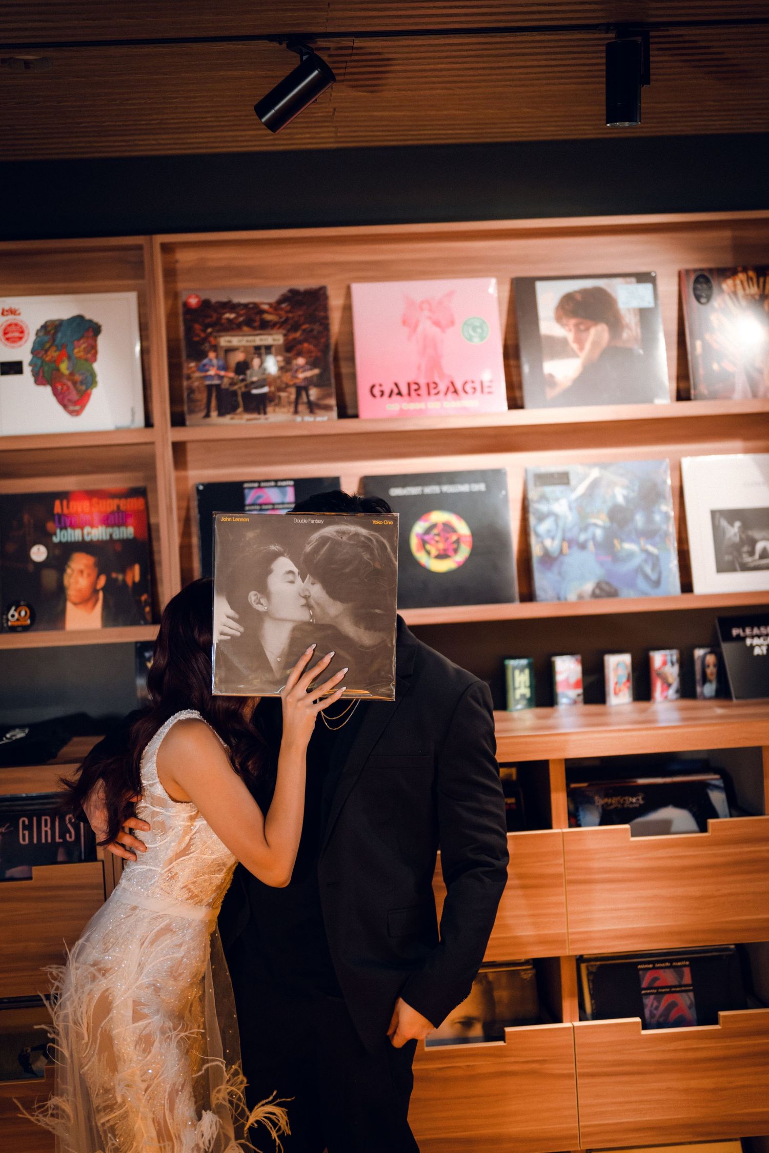 A romantic scene in a restaurant with wooden walls adorned with vintage posters and artwork.