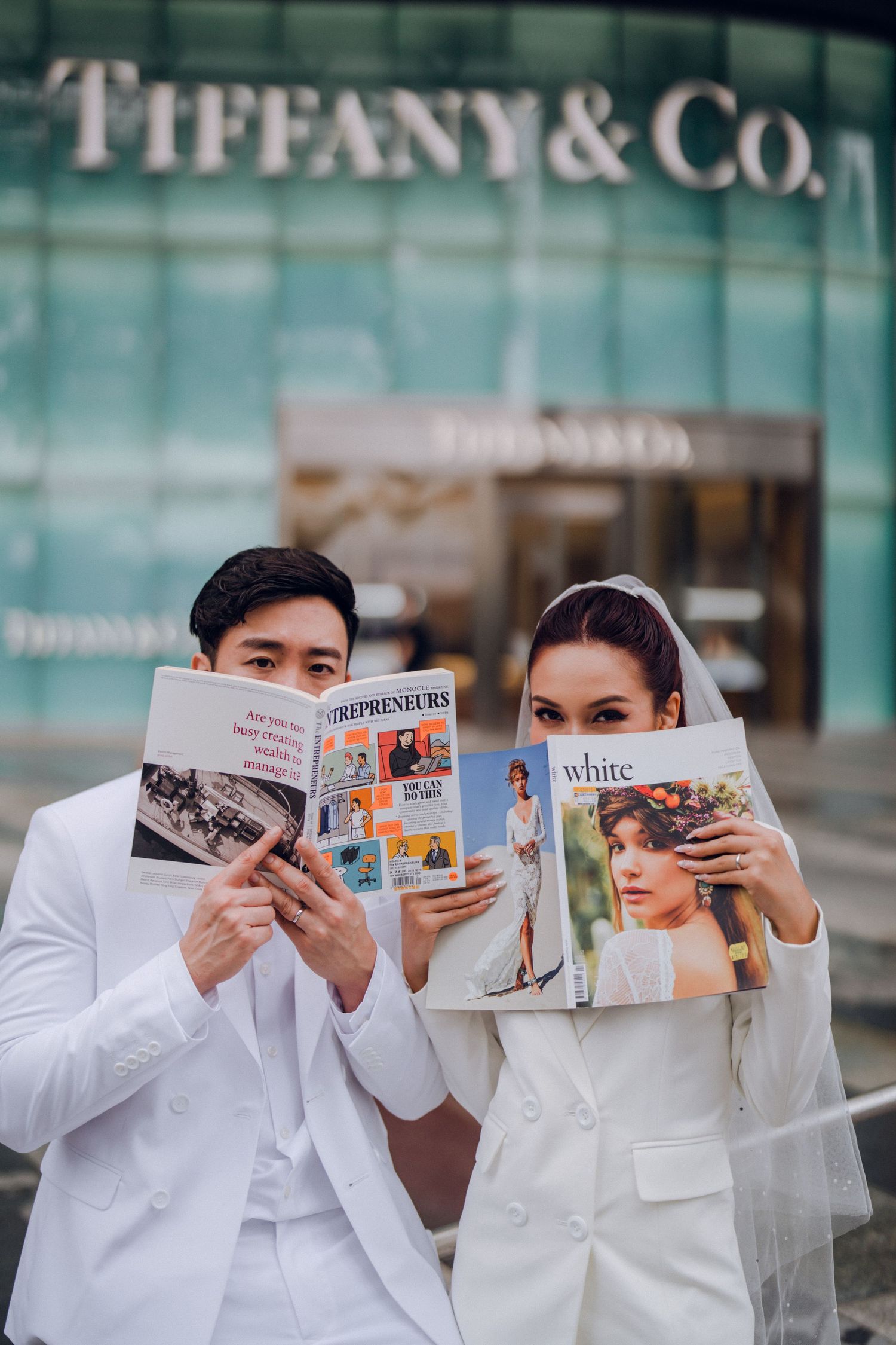 Creative photo shoot with magazines in front of Tiffany & Co store.