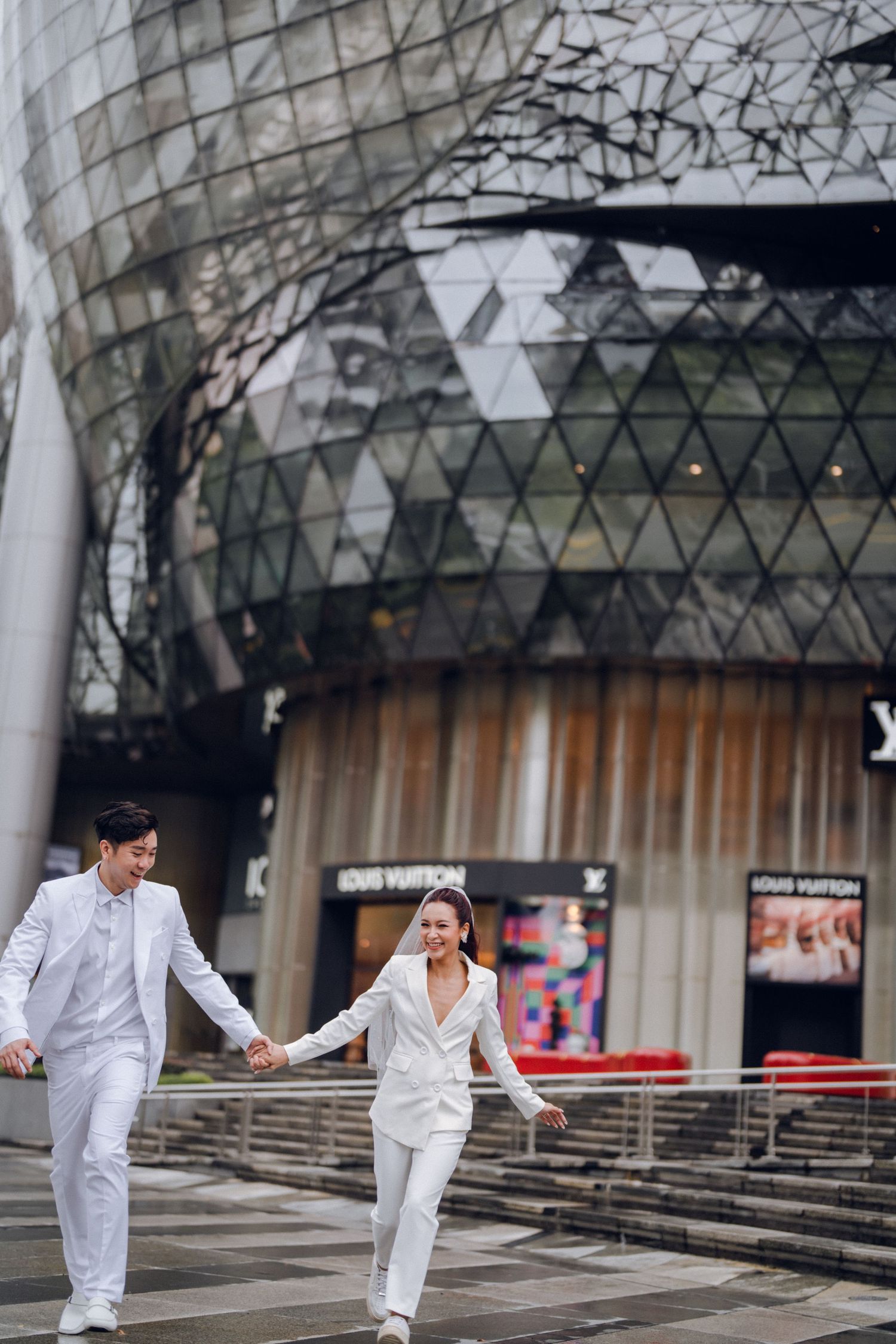 Artistic dance poses captured in modern architectural setting with geometric patterns.