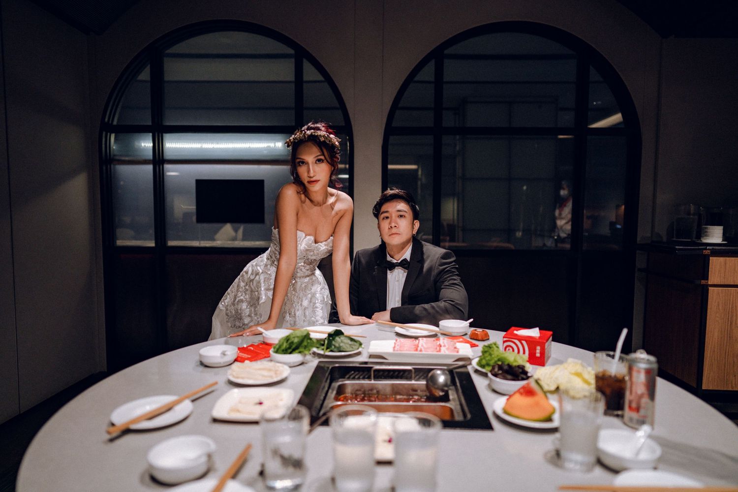 Couple shares playful moment during romantic dinner at restaurant.