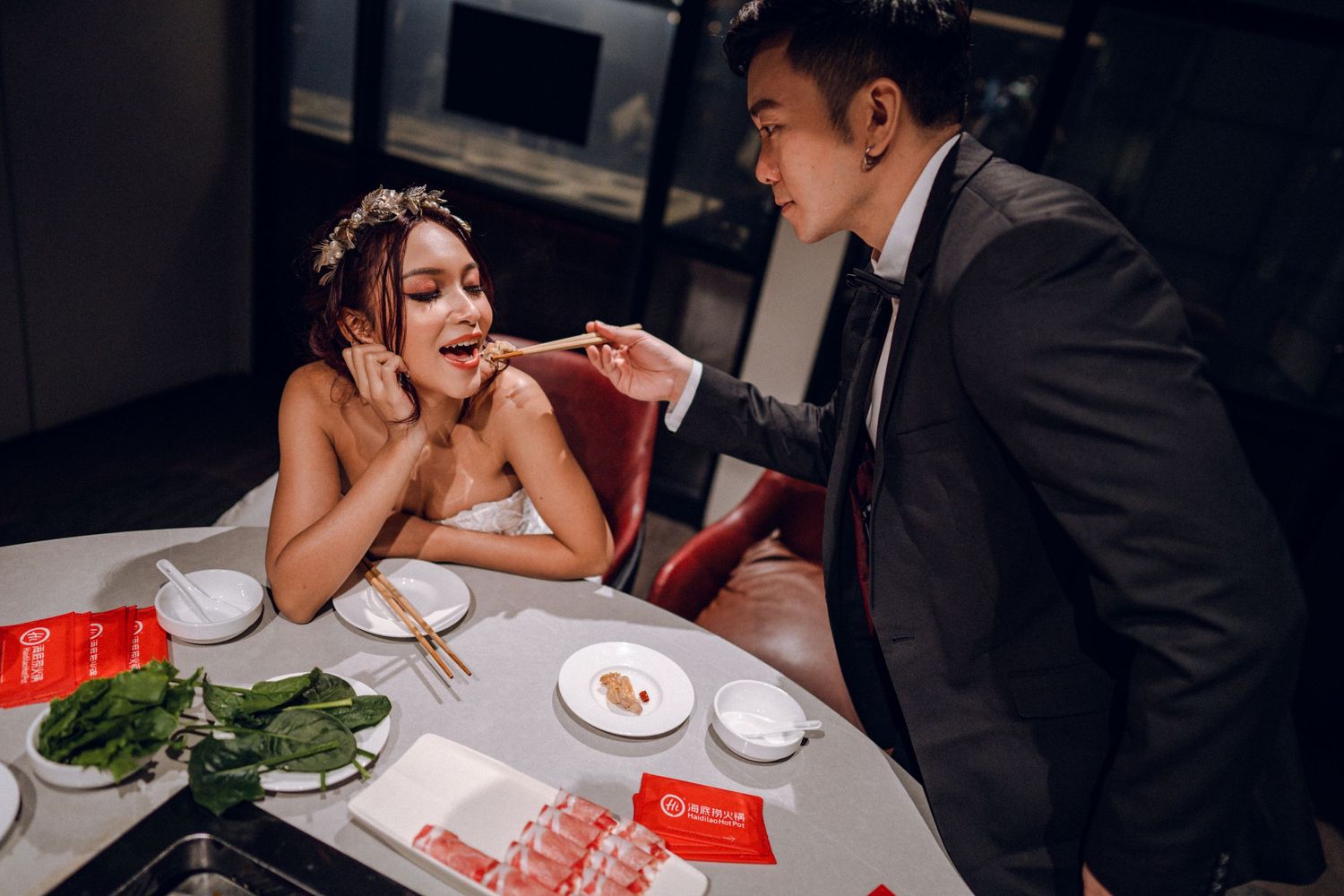 Couple shares intimate dining experience at dimly lit restaurant table.