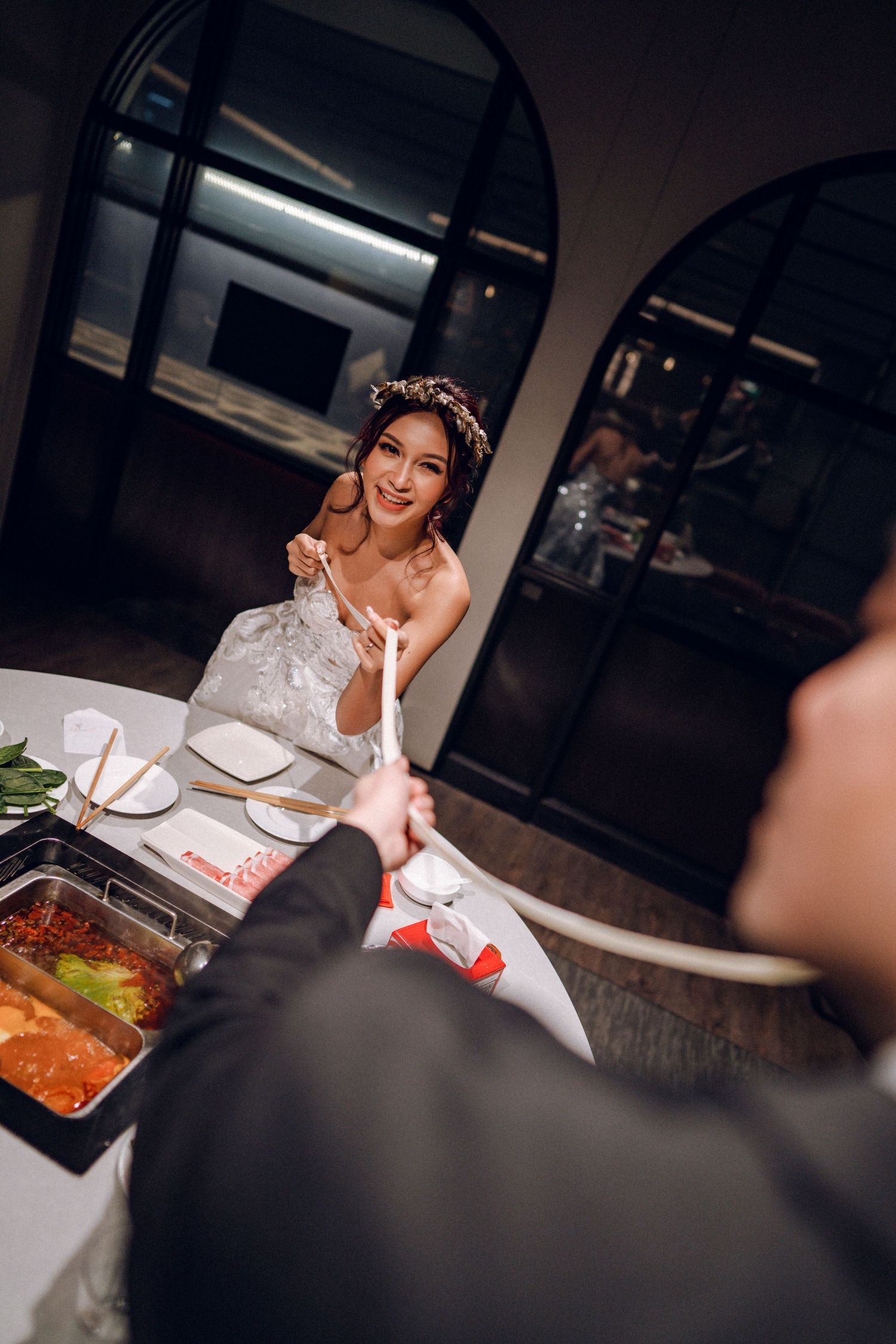 Intimate restaurant scene with diners enjoying a meal at an elegantly set table.
