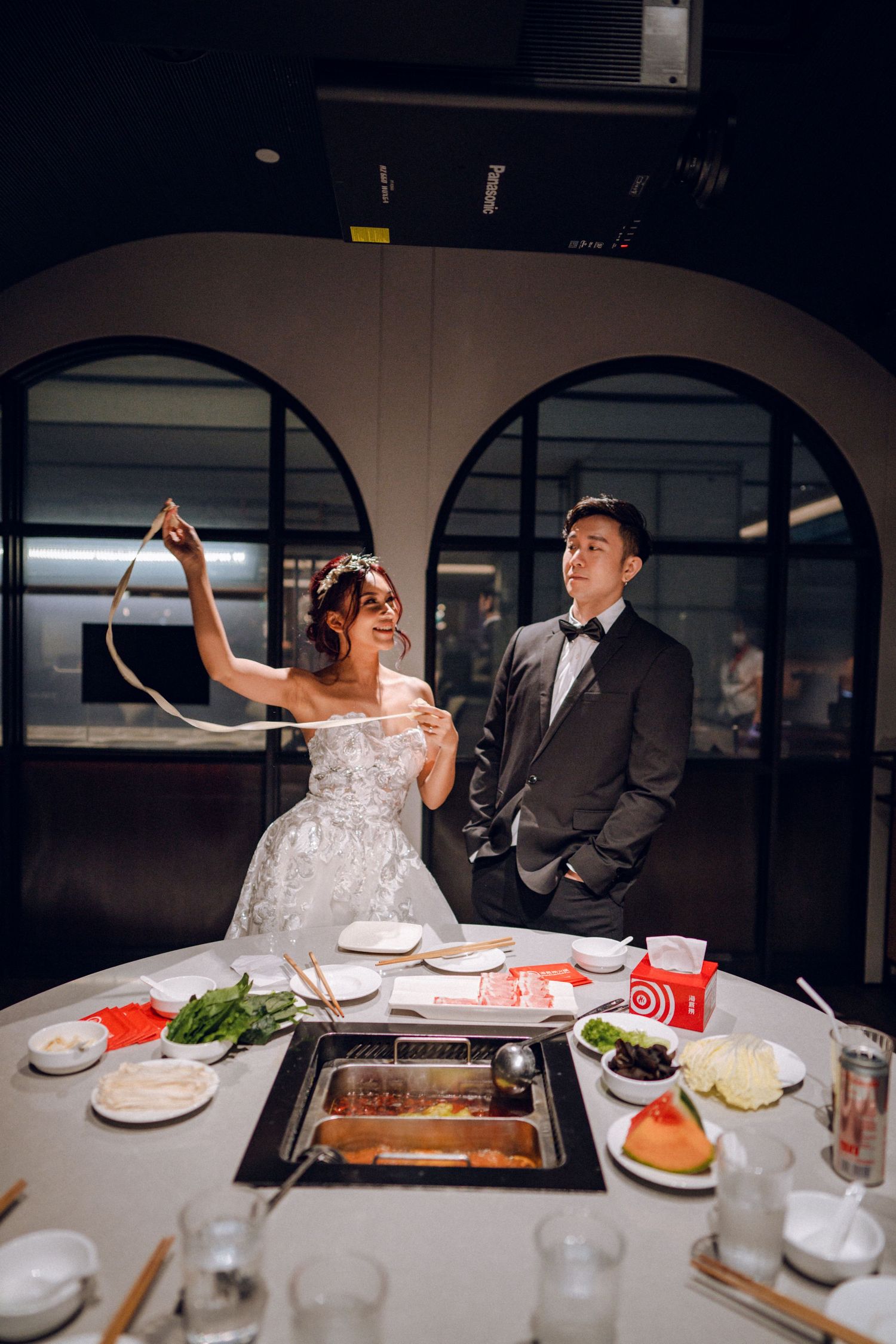 Formal dining experience with couple sharing hot pot dishes at an upscale Asian restaurant.