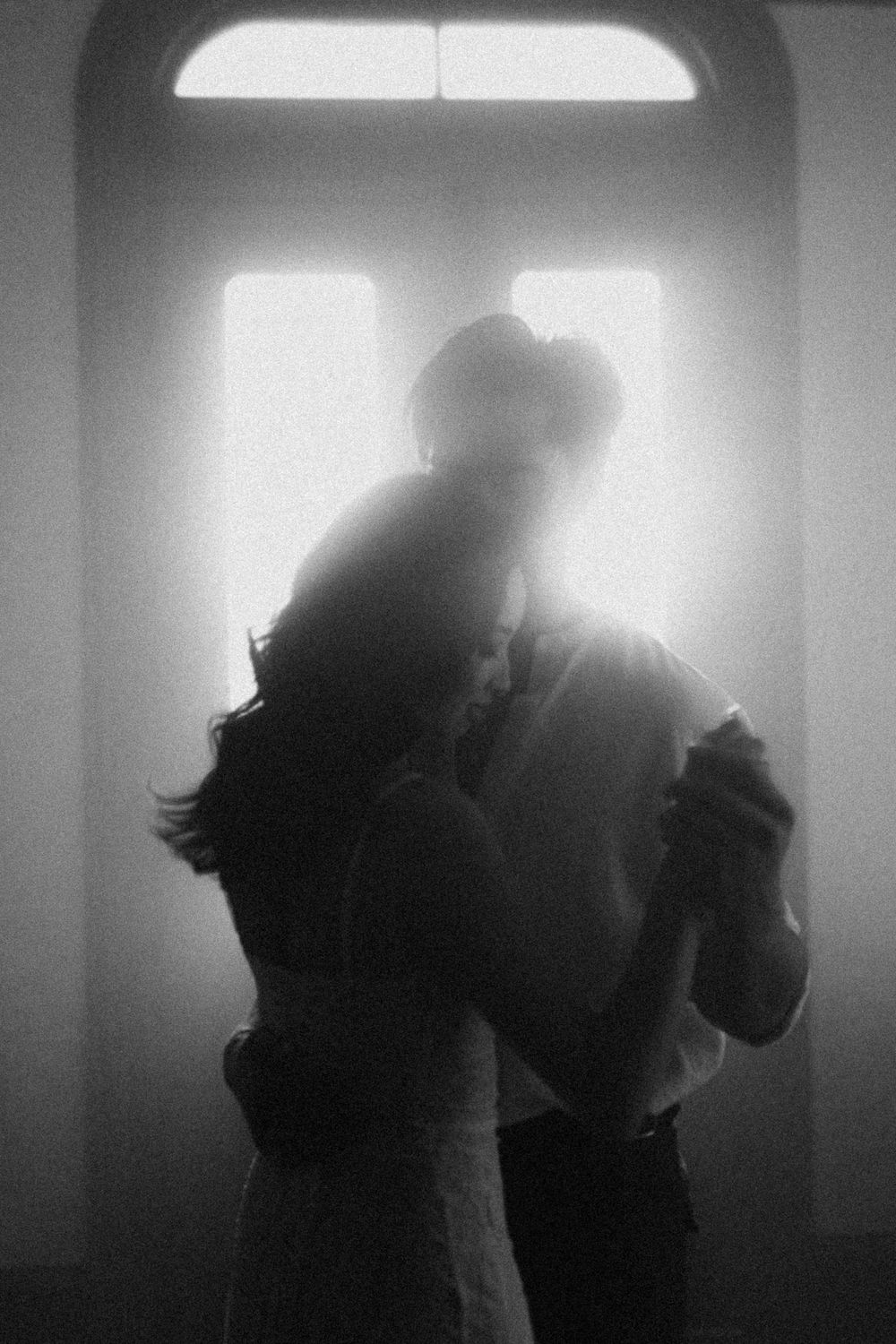 Silhouettes of figures in backlit dramatic lighting creating a dreamy atmosphere.
