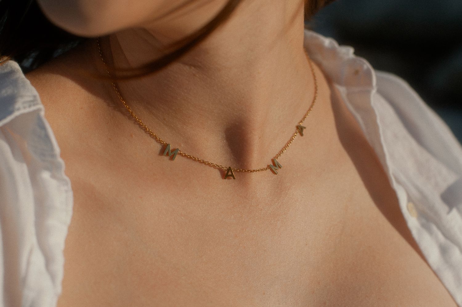 Close-up of a delicate star-shaped necklace on a bride's neck.