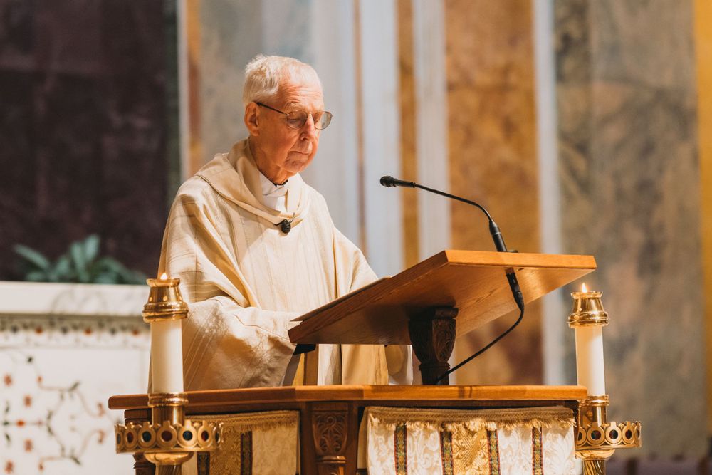 Priest conducting a wedding ceremony at an elaborate church altar with golden details.
