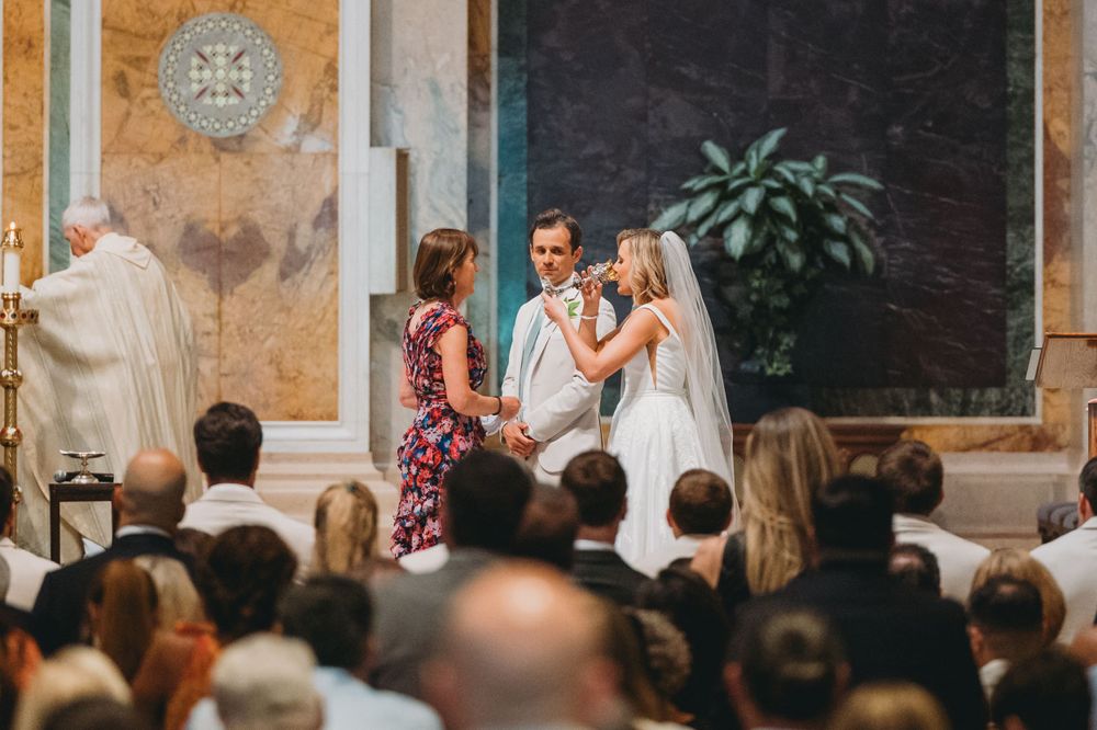 communion during Catholic wedding ceremony inside Cathedral of St. Matthew the Apostle