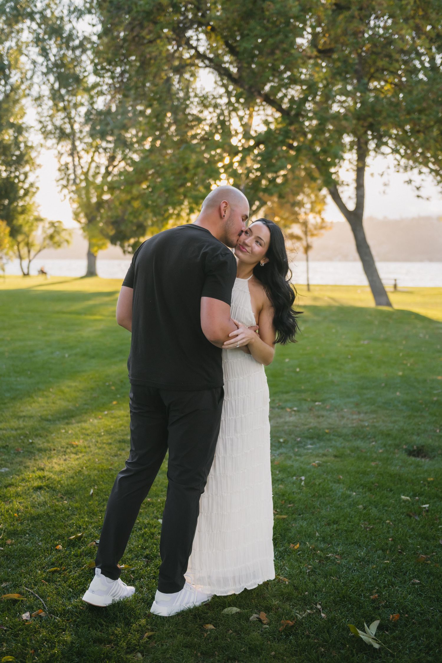 husband kissing his wife's cheek outside